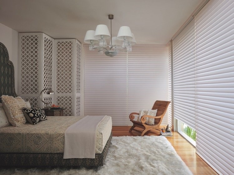 A bedroom with a variety of white textures and patterns